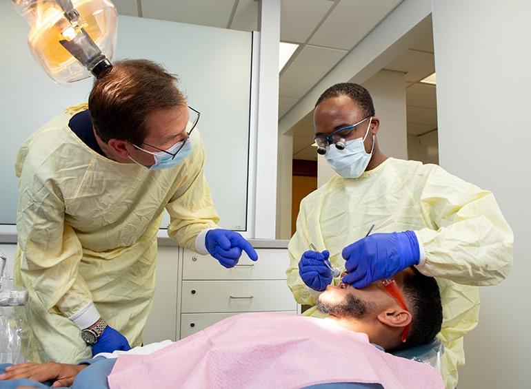 dental student about to  into patient's mouth