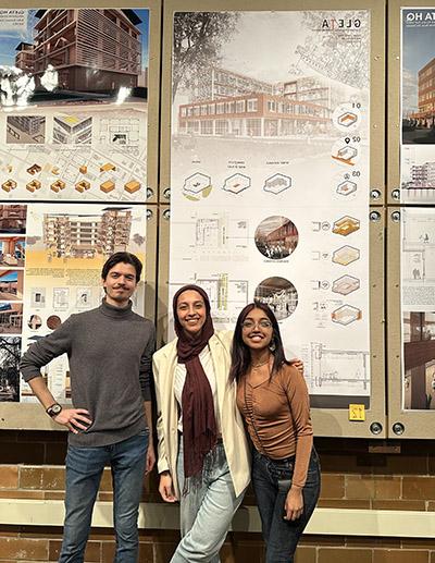 Dolin Diaz, Farah Ossaimee and Marcus Puste pose for a photo in front of their project, TIMBR.