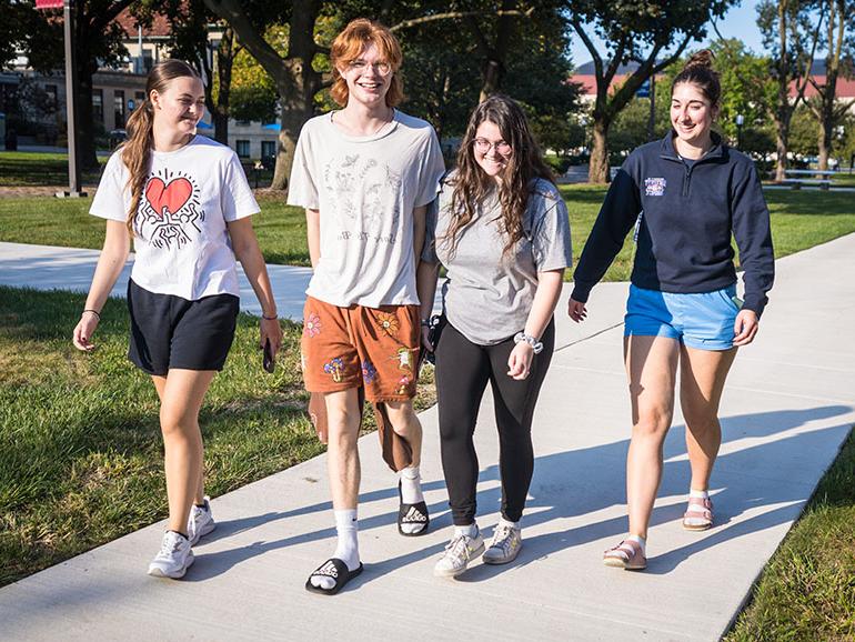 Four students walk campus during UDM's Homecoming.